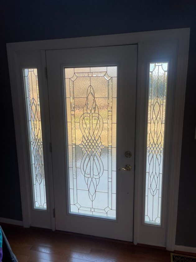 White French doors with decorative glass sidelights in a home's entryway
