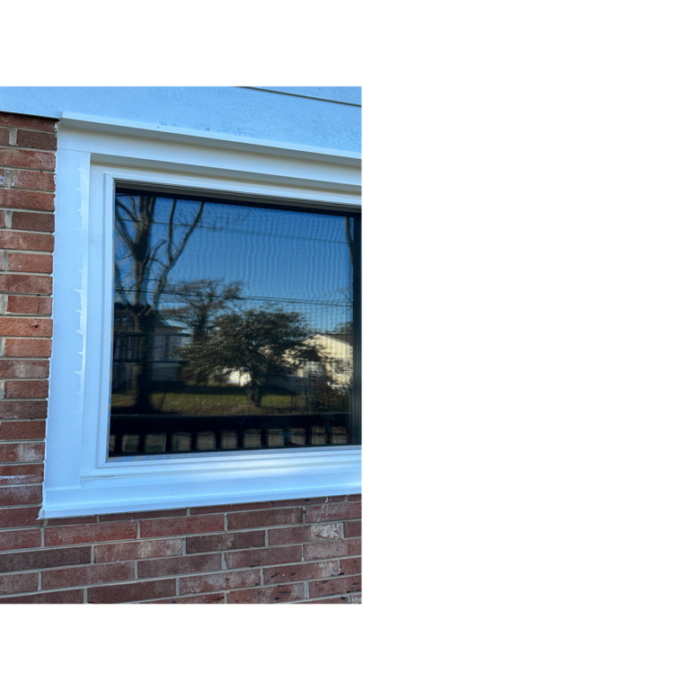 A new triple-pane glass window with a white composite frame installed in a brick house wall